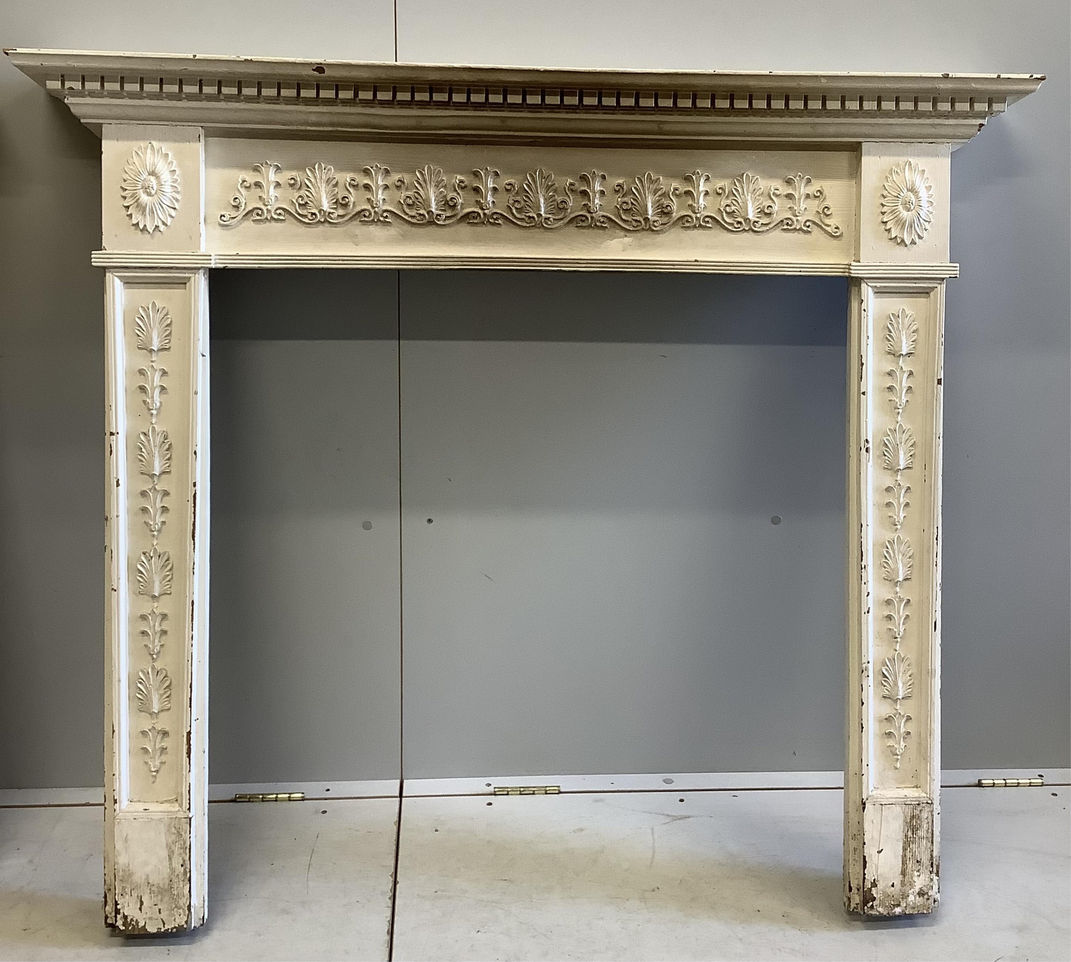 An 18th century style painted pine fire surround and one other, larger width 138cm, height 116cm. Condition - fair